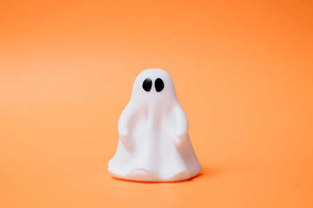 Artificial beautiful ghost on an orange background. Copy space for text. Festive conceptの写真素材