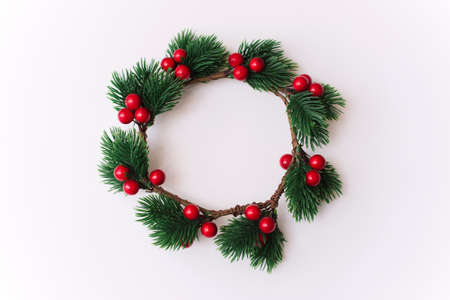 Christmas wreath with red berries on a white background.の写真素材