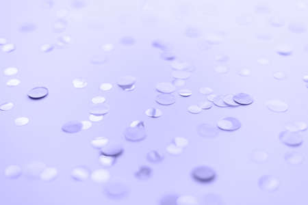 Violet and round confetti on a purple pastel background in very peri colors. Color of the year 2022. Template for advertising, blog, discounts and textの写真素材