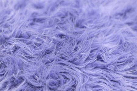 Purple soft fur for background or texture. Fluffy blue fur blanket. The color of 2022 very peri. Flat lay, top view, copy spaceの写真素材