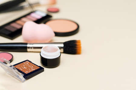 Set of professional decorative cosmetics, makeup tools and accessory on colored background. Beauty, fashion and shopping concept. Flat lay composition, top viewの写真素材