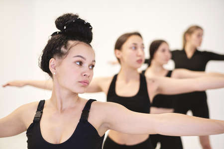 The trainer shows how to stretch correctly to a group involved in sports.の写真素材