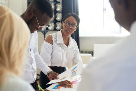 African american female ceo leading corporate multiracial team meeting talking to diverse businesspeople, black woman executive discussing project plan at group multi-ethnic briefing in officeの写真素材