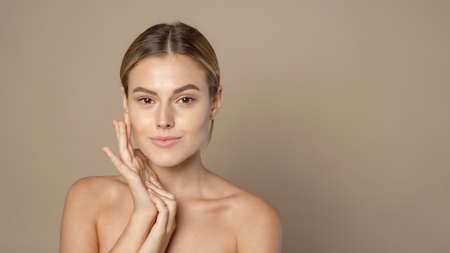 Beautiful Caucasian young woman with perfect skin touching face. Web-bannerの写真素材