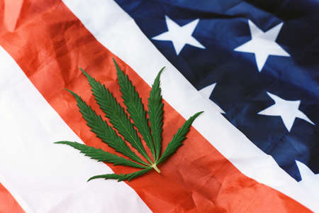 Cannabis or hemp leaf on the USA flag. View from above. Legalization of marijuanaの写真素材