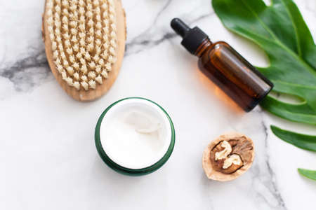 Moisturizing cream on a marble background for spa treatments at home.の写真素材