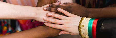 National diversity. People of different appearance and nationality stand in a circle together and hold hands. Team building and partnership business concept. Web banner.の写真素材