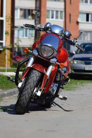 Orange motorcycle on the street in a summer sunny dayの写真素材