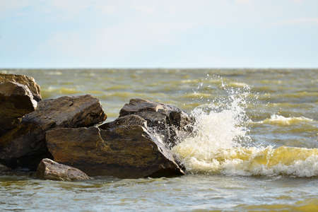 Waves and drops of water on the shoreの写真素材