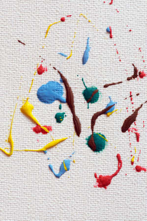 multicolored artist paint drops on fine art canvasの写真素材