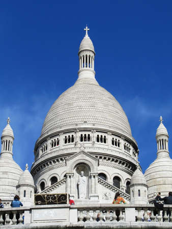 View from below of the Montmartre cathedral with its white domes on the blue sky                               の写真素材