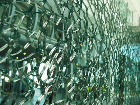 Close-up view of a cracked glass parapet の写真素材