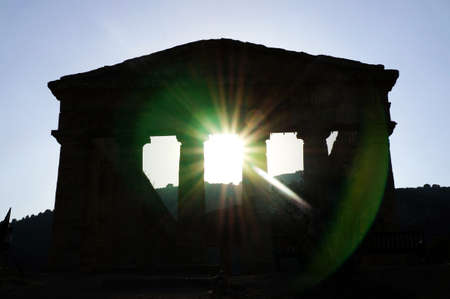 The facade of the Segesta greek temple in Sicily seen in backlight