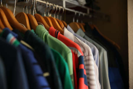 A man s clothes hanging in the closetの写真素材