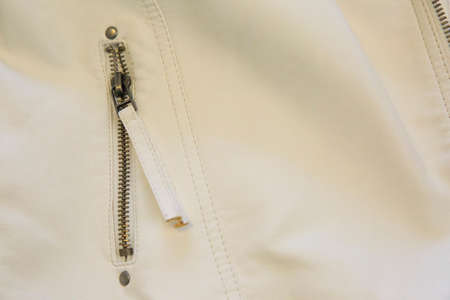 Zipper on a white leather jacketの写真素材