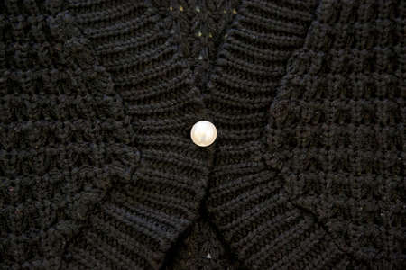 Black sweater with a pearl button