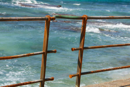 Rusty fence in the seaの写真素材