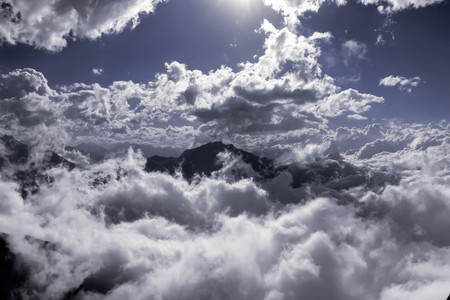 Sunlight through the cloudy sky and a view of the mountainsの写真素材