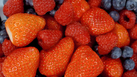 Close up of a pile of strawberries and Grapes