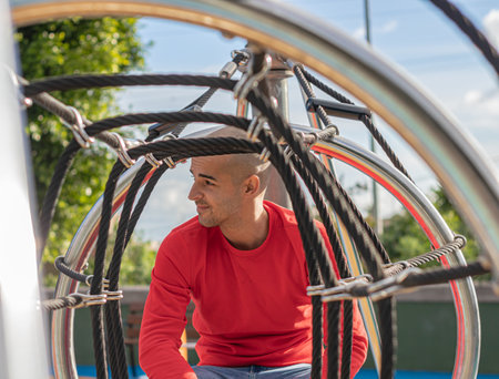 Young man relaxing and walking at the park, enjoing life and smiling in the afternoon