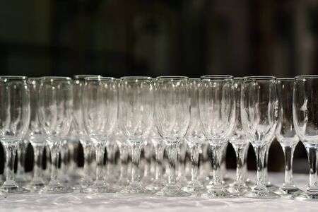 glasses of white wine in a row on the table in pyramid. sun lightの写真素材