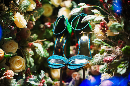 green shoes in Christmas tree, snow and decorationsの写真素材