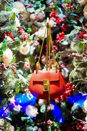red handbag in Christmas tree, snow and decorationsの写真素材