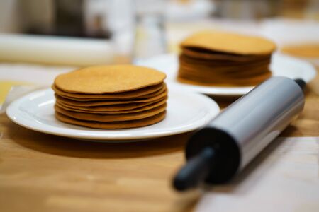 rolling pin with cake on the table. make the cakes. close-upの写真素材
