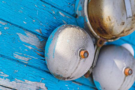 Classic alarm bell on a blue wooden wall in the winter on the outside. closeupの写真素材