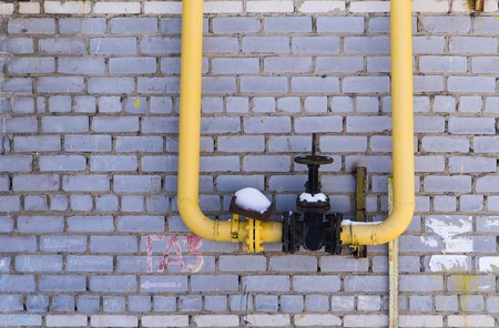 gas equipment, pipes and shut-off valve on the background wall.の写真素材