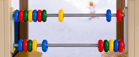 children's abacus in the children's outdoor area in the winter. close up