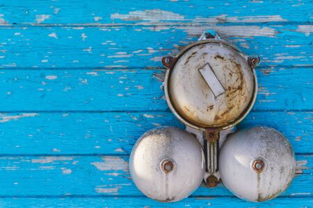 Classic alarm bell on a blue wooden wall in the winter on the outside. Close upの写真素材