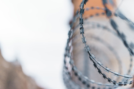 Fence with barbed wire. focus with shallow depth of fieldの写真素材