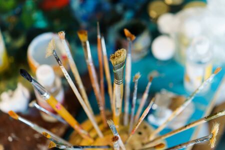 artist brushes in the stand on blurred background.の写真素材