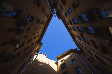 Yard-well of bottom-up with grey sky at twilight, classical architecture of old Saint Petersburg, Russia.の写真素材