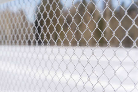 Metallic mesh coated with frost in the cold. Background, space for text