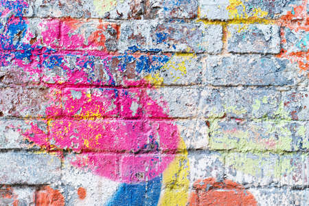 the old brick wall in colored paint. backgroundの写真素材