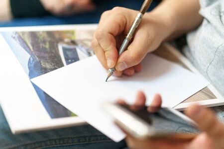 a man writes a pencil on white paperの写真素材