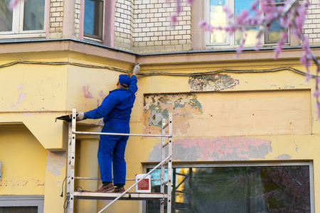 a worker repairing the wall of a buildingの写真素材