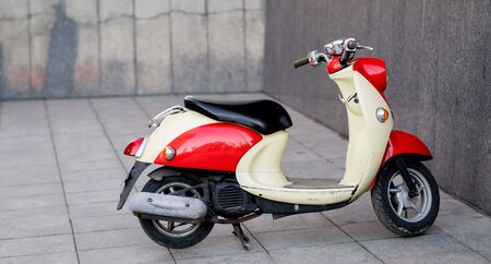 City Scooter parked. red-beige color. moped, motobikeの写真素材