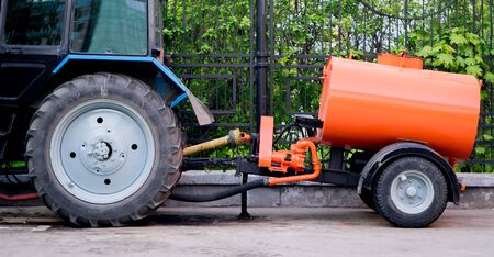 tractor with trailer barrel. standing at the fence.
