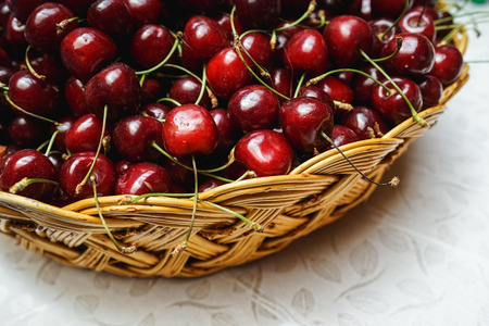 a lot of fresh cherries in a basketの写真素材