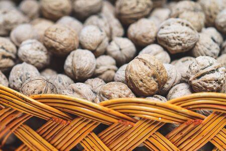 lot of walnuts in braided basket close upの写真素材