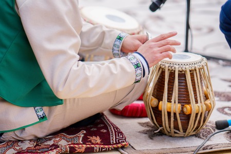 man plays on classical drums of Tajikistanの写真素材