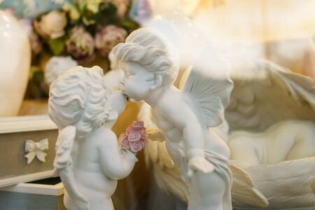 statuettes two Angels Kiss. Beautiful toys from porcelainの写真素材