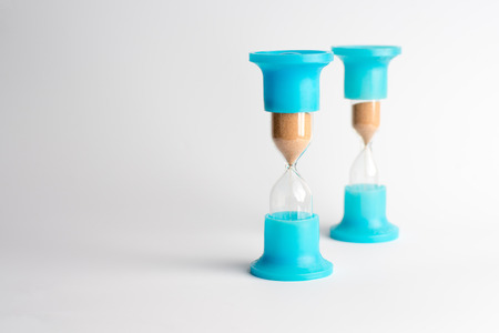 Hourglass with Yellow Sand on White Backgroundの写真素材