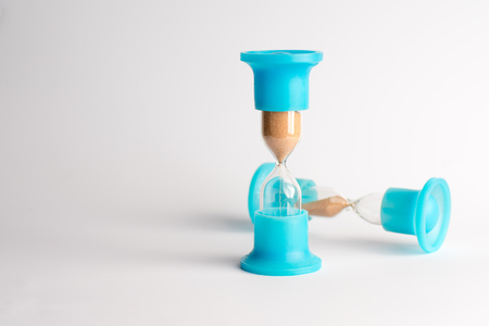 Hourglass with Yellow Sand on White Backgroundの写真素材