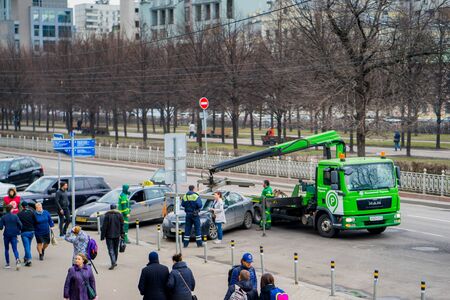 MOSCOW RUSSIA - APRIL 22 2017: Traffic police officers on the street wants lifting the car on the...
