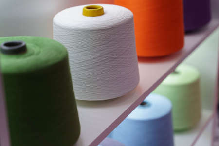 large group of bobbin thread cones on the shelf