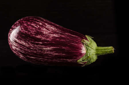 Fresh purple eggplant with waterdrops isolated on black backgroundの写真素材